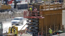 Construction workers build a structure along Interstate 95 in Philadelphia, Tuesday, Sept. 3, 2024.