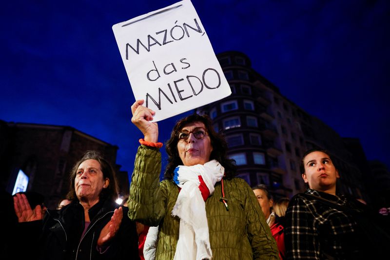 © Reuters. A woman holds a placard that reads