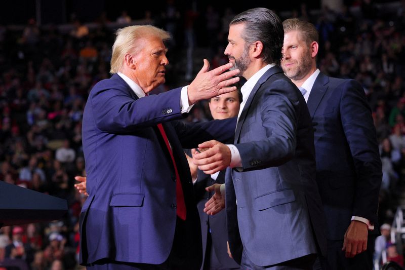 © Reuters. FILE PHOTO: Republican presidential nominee and former U.S. President Donald Trump approaches to embrace Donald Trump Jr at his campaign rally, at PPG Paints Arena in Pittsburgh, Pennsylvania, U.S., November 4, 2024. REUTERS/Brian Snyder/File Photo