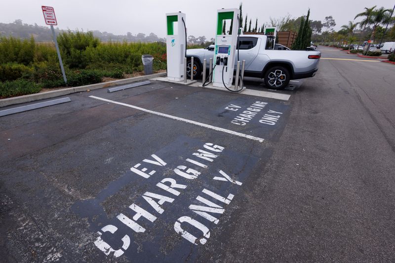 © Reuters. Caption: Electric vehicle chargers are shown in a shopping center parking lot in Oceanside, California, U.S.,October 19, 2023. REUTERS/Mike Blake/File Photo