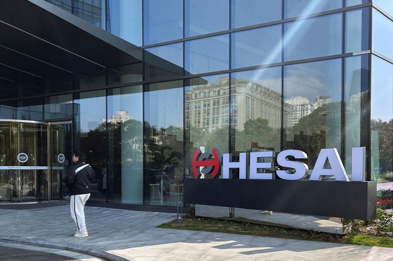 © Reuters. A person walks outside the headquarters of lidar sensor maker Hesai Group in Shanghai, China November 26, 2024. REUTERS/Zoey Zhang