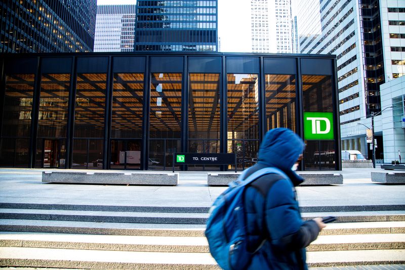 © Reuters. FILE PHOTO: A person walks past a sign for TD Canada Trust in Toronto, Ontario, Canada December 13, 2021. REUTERS/Carlos Osorio/File Photo