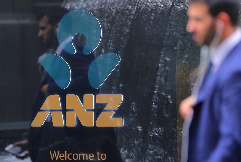 © Reuters. FILE PHOTO: A pedestrian is reflected in the window of a branch of the Australia and New Zealand Banking Group (ANZ) in central Sydney, Australia, October 25, 2017. REUTERS/Steven Saphore/File Photo