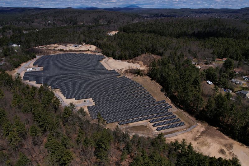 © Reuters. FILE PHOTO: Solar panels are arrayed on Earth Day in Athol, Massachusetts, U.S., April 22, 2022. Picture taken with a drone.     REUTERS/Brian Snyder/File Photo