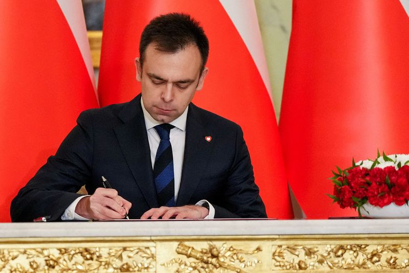 © Reuters. FILE PHOTO: Newly appointed Polish Finance Minister Andrzej Domanski attends the cabinet swearing-in ceremony at the Presidential Palace in Warsaw, Poland December 13, 2023. REUTERS/Aleksandra Szmigiel