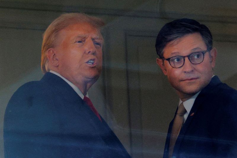 © Reuters. FILE PHOTO: U.S. President-elect Donald Trump is joined by U.S. House Speaker Mike Johnson (R-LA) at the Army-Navy football game in Landover, Maryland, U.S., December 14, 2024. REUTERS/Brian Snyder/File Photo