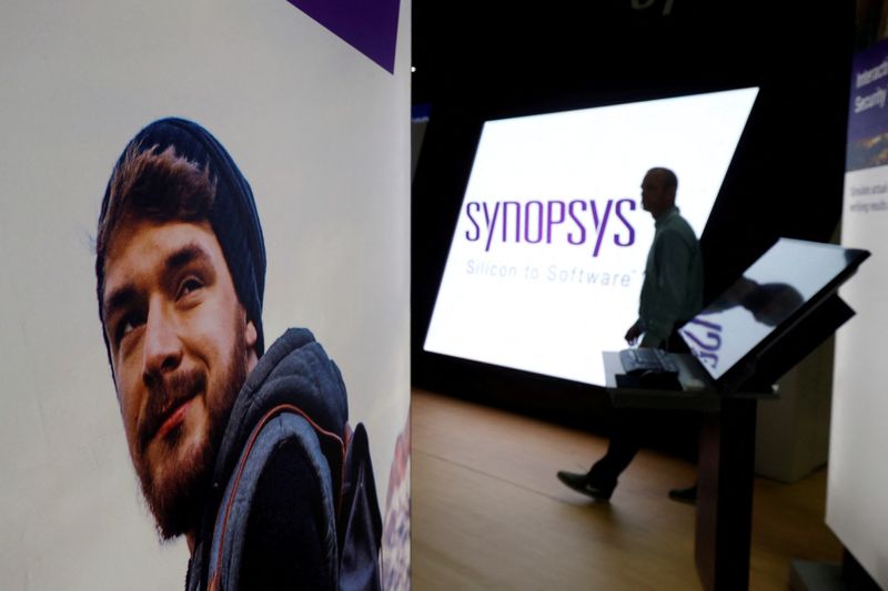 © Reuters. FILE PHOTO: A man walks through the Synopsys booth during the Black Hat information security conference in Las Vegas, Nevada, U.S. on July 26, 2017. REUTERS/Steve Marcus/File Photo