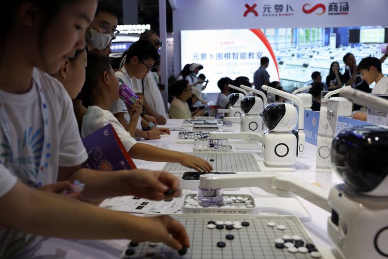 © Reuters. Visitors play Go against SenseRobots displayed at the SenseTime booth during the World Robot Conference in Beijing, China August 21, 2024. REUTERS/Florence Lo/File Photo