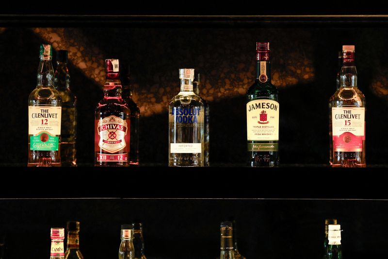 © Reuters. Bottles of Pernod Ricard's brands are displayed at a bar in Gurugram, India, November 26, 2024. REUTERS/Priyanshu Singh