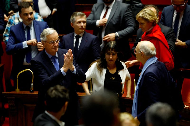 © Reuters. French Prime Minister Michel Barnier reacts after the result of the vote on the first motion of no-confidence against the French government, tabled by the alliance of left-wing parties the