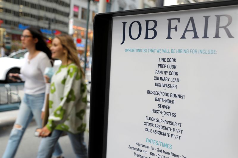 © Reuters. FILE PHOTO: Signage for a job fair is seen on 5th Avenue in Manhattan, New York City, U.S., September 3, 2021. REUTERS/Andrew Kelly/File Photo