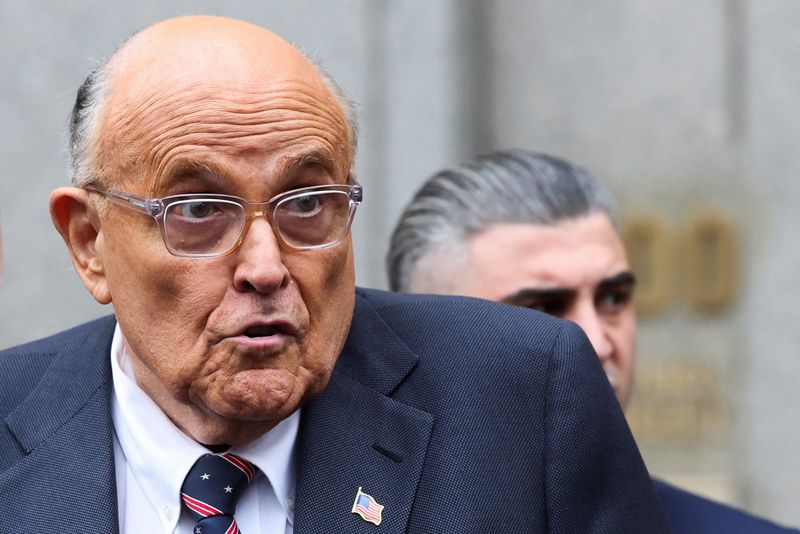 © Reuters. FILE PHOTO: Former Donald Trump lawyer and former New York City Mayor Rudolph Giuliani speaks to the media as he departs the U.S. Federal court following a hearing in his case to surrender valuables to Georgia election workers he was found to have defamed, in New York City, U.S., November 26, 2024. REUTERS/Brendan McDermid/File Photo