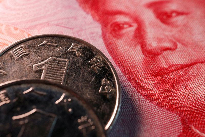 © Reuters. FILE PHOTO: Coins and a banknote of China's yuan are seen in this illustration picture taken February 24, 2022. REUTERS/Florence Lo/Illustration/File Photo