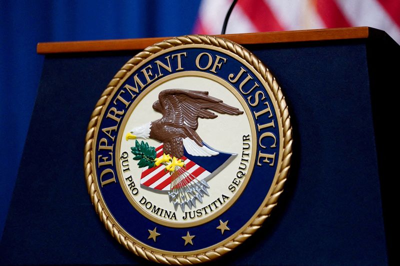 © Reuters. FILE PHOTO: The seal of the U.S. Justice Department is seen on the podium in the Department's headquarters briefing room before a news conference with the Attorney General in Washington, January 24, 2023. REUTERS/Kevin Lamarque//File Photo/File Photo