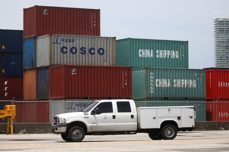 © Reuters. FILE PHOTO: A truck drives past Cosco and China Shipping shipping containers in the Port of Miami in Miami, Florida, U.S., May 19, 2016.  REUTERS/Carlo Allegri/File Photo