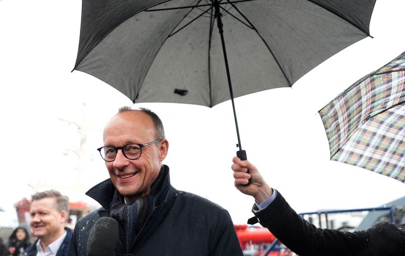 © Reuters. FILE PHOTO: Christian Democratic Union (CDU) leader and CDU top candidate for the upcoming general election Friedrich Merz answers journalists' questions as he visits the Hafencity in Hamburg, Germany, January 10, 2025.  Marcus Brandt/Pool via REUTERS/File Photo