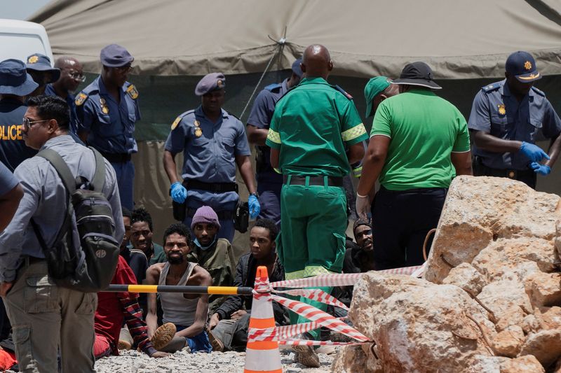 © Reuters. Rescued miners are seen as they are processed by police after being rescued at the mine shaft where rescue operations are ongoing as attempts are made to rescue illegal miners who have been underground for months, in Stilfontein, South Africa, January 14, 2025. REUTERS/Ihsaan Haffejee