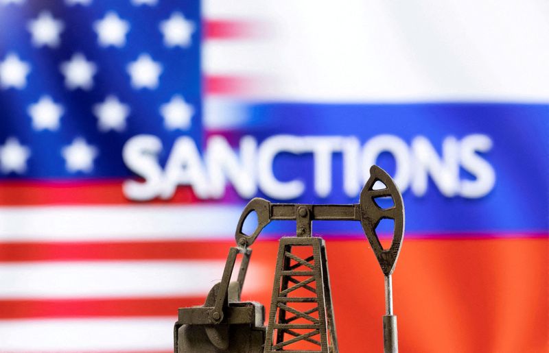 © Reuters. FILE PHOTO: A model of a pump jack is seen in front of the displayed word