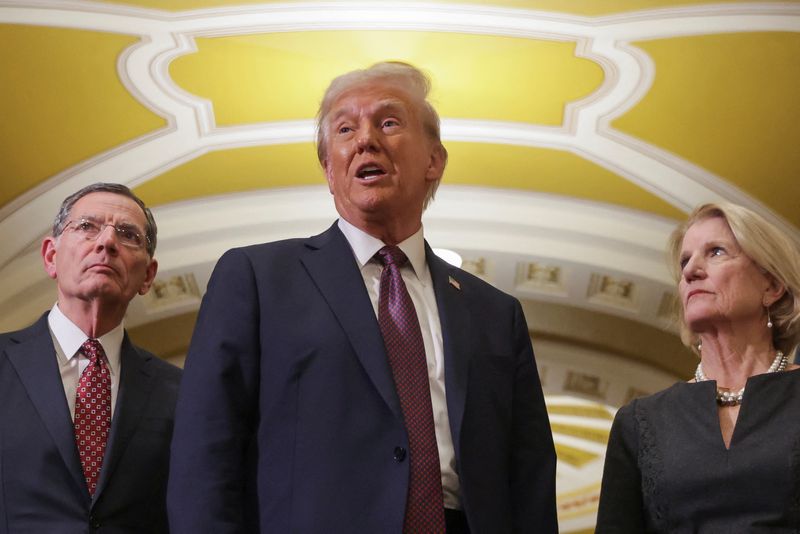 © Reuters. FILE PHOTO: U.S. President-elect Donald Trump speaks as U.S. Senator Shelley Moore Capito (R-WV) and U.S. Senator John Barrasso (R-WY) look on, after a meeting with Republicans in Congress at the U.S. Capitol building in Washington, U.S. January 8, 2025. REUTERS/Jeenah Moon/File photo