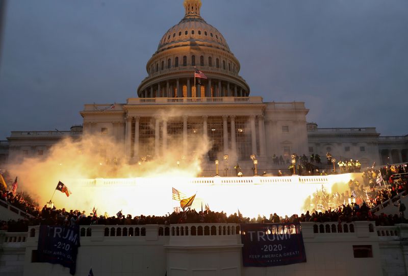 © Reuters. FILE PHOTO: An explosion caused by a police munition is seen while supporters of U.S. President Donald Trump riot in front of the U.S. Capitol Building in Washington, U.S., January 6, 2021. REUTERS/Leah Millis/File Photo