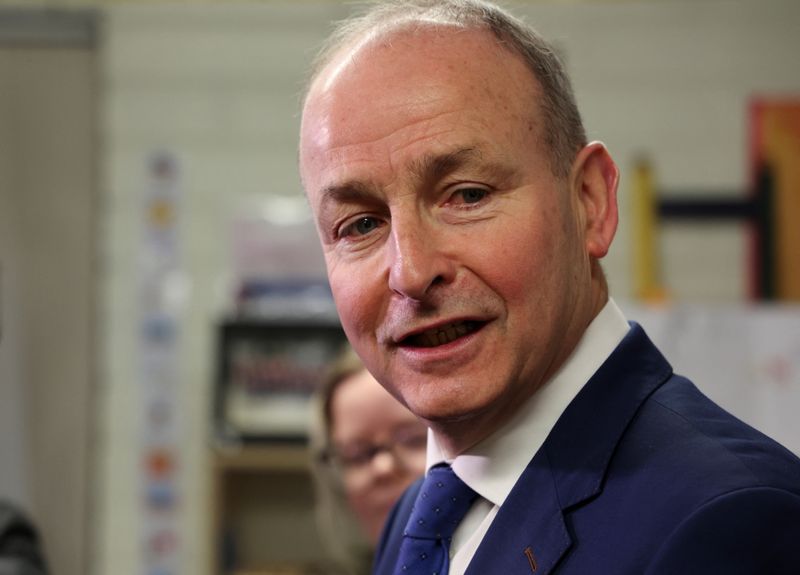 © Reuters. FILE PHOTO: Ireland's Tanaiste (Deputy Prime Minister) and leader of Fianna Fail, Micheal Martin speaks to the media after voting at a polling station in St. Anthony's Boys National school, during Ireland's general election, in Cork, Ireland, November 29, 2024. REUTERS/Damien Eagers/File Photo