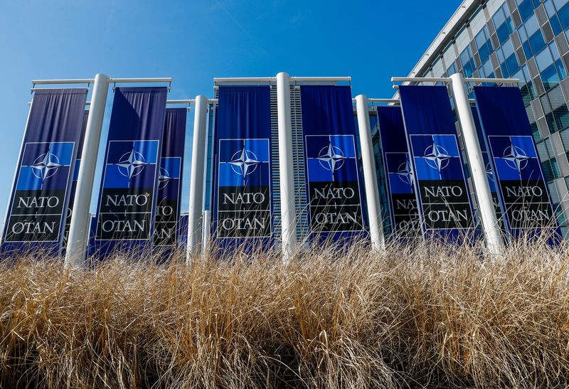 © Reuters. FILE PHOTO: Banners displaying the NATO logo are placed at the entrance of new NATO headquarters during the move to the new building, in Brussels, Belgium April 19, 2018.  REUTERS/Yves Herman/File Photo