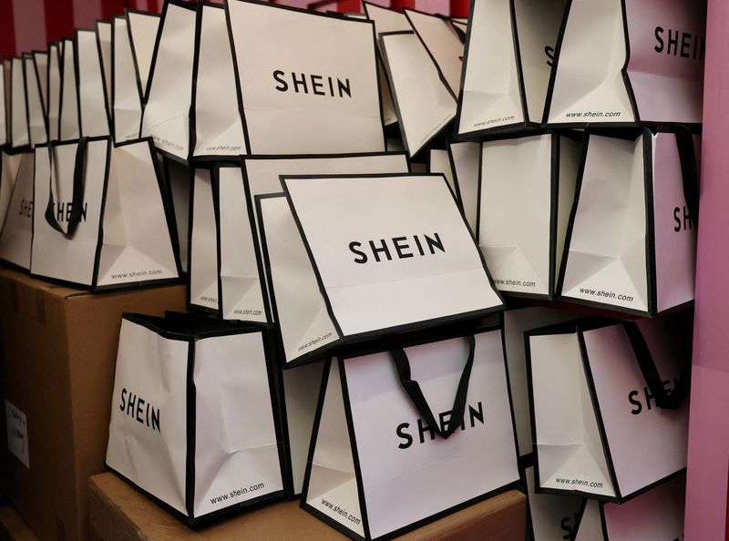 © Reuters. FILE PHOTO: A company logo for fashion brand Shein is seen on a pile of gift bags on its Christmas bus as part of a nationwide promotional tour in Liverpool, Britain, December 14, 2024. REUTERS/Phil Noble/File Photo