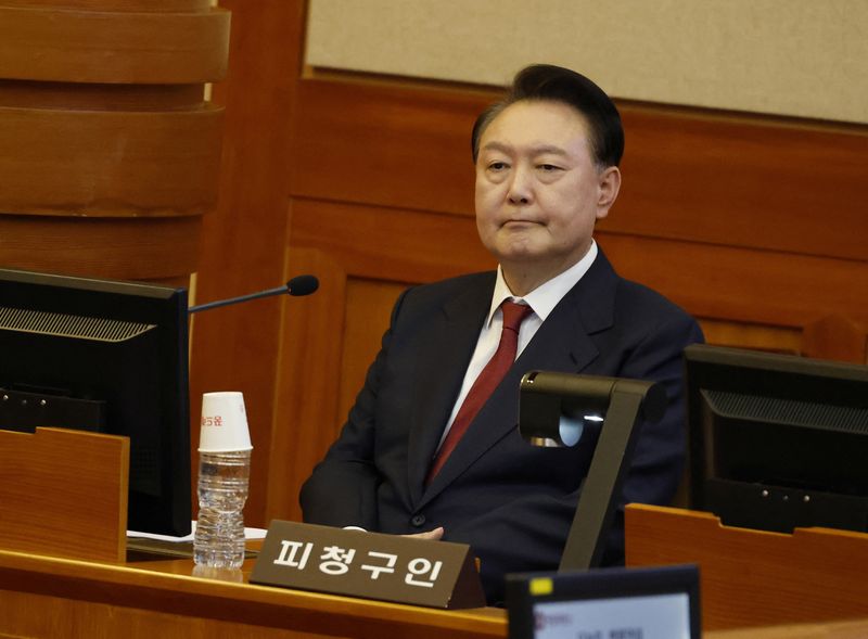 © Reuters. FILE PHOTO: South Korea’s impeached President Yoon Suk Yeol attends the fourth hearing of his impeachment trial over his short-lived imposition of martial law at the Constitutional Court in Seoul, South Korea, 23 January 2025.    JEON HEON-KYUN/Pool via REUTERS/File Photo