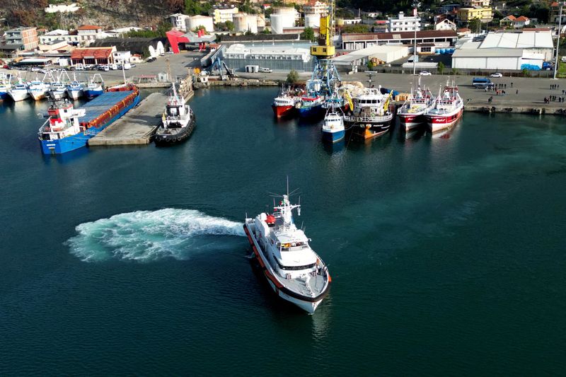 © Reuters. FILE PHOTO: A drone view shows an Italian coast guard vessel departing for Italy with migrants, who were intercepted at sea and later detained at a reception facility in Albania, after a court in Rome overturned their detention orders, in Shengjin, Albania, October 19, 2024. REUTERS/Florion Goga/File Photo