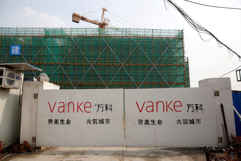 © Reuters. FILE PHOTO: A China Vanke logo is seen at a gate of a construction site in Shanghai, China, March 21, 2017. REUTERS/Aly Song//File Photo